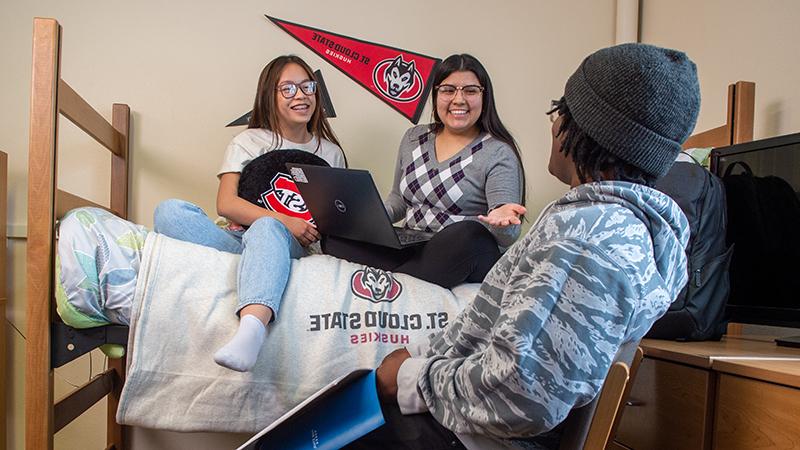 Three students in dorm room